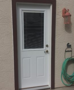 Two panel metal door with mini blinds