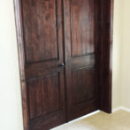 Installing double interior knotty alder doors.