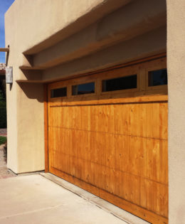 Refinishing wooden garage door.
